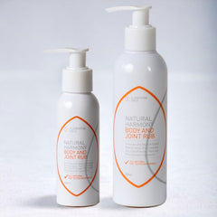 Two-bottles-of-Natural-Harmony-Body-and-Joint-Rub-on-a-light-gray-background